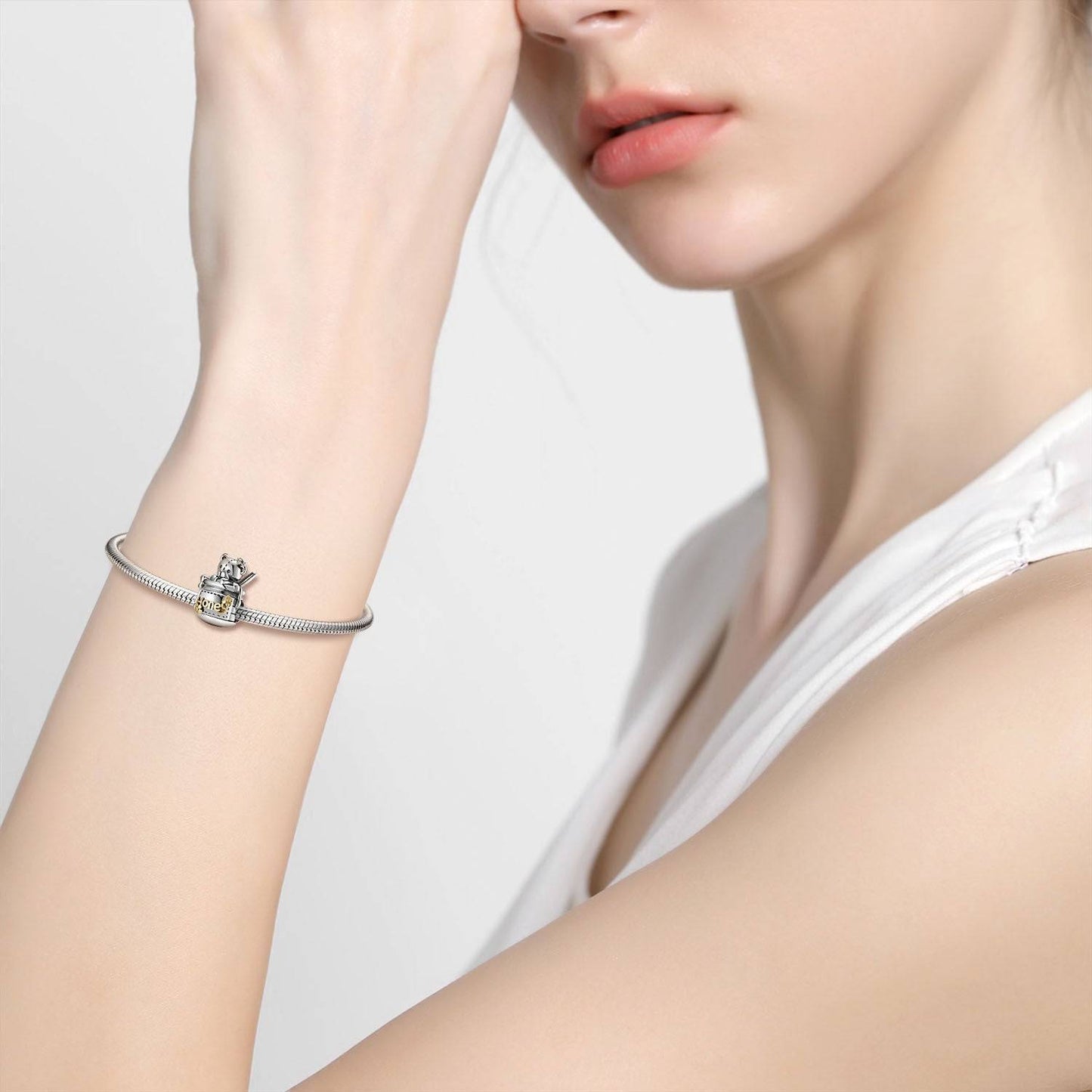 Model wearing a silver bracelet with the Honey Bear Charm, highlighting its elegant and nostalgic appeal.