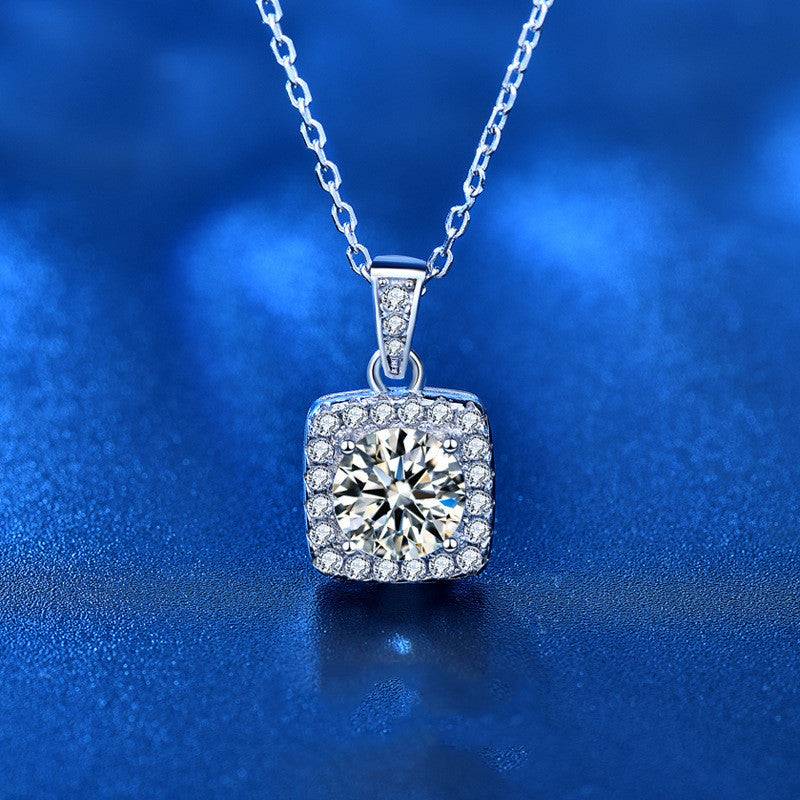 Square pendant moissanite necklace displayed on a blue background, highlighting the brilliance of the gemstone.