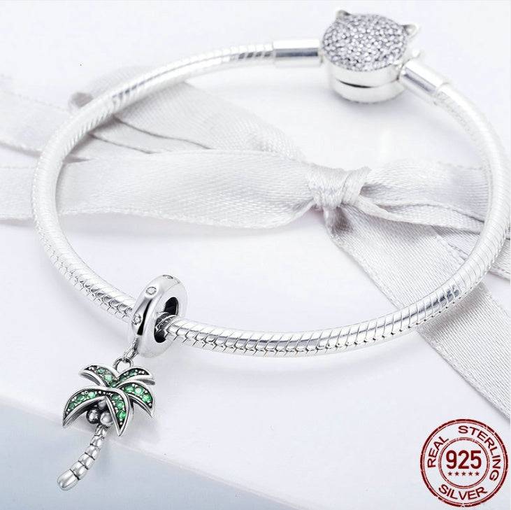 Silver bracelet featuring coconut tree charm.