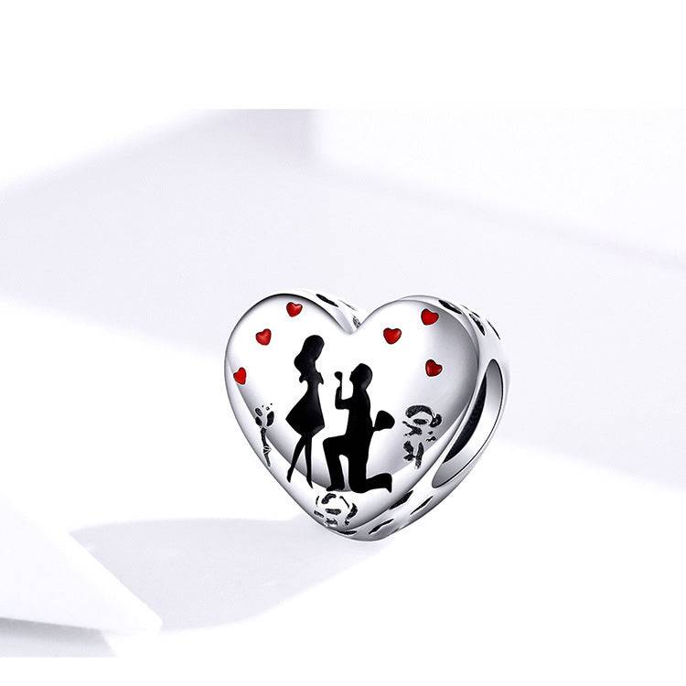 Heart charm featuring couple silhouette