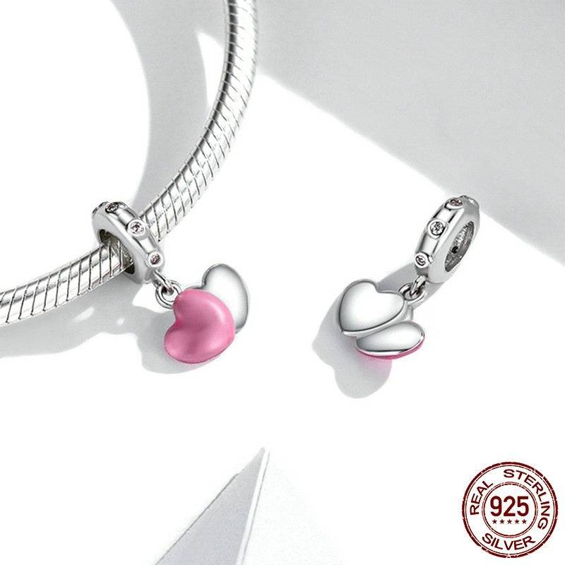 Pink Heart Tag Charm displayed on a silver bracelet, highlighting its elegant pink enamel and crystal details.