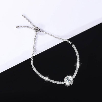 Silver moissanite galaxy bracelet with a clear central stone, featuring a celestial design and sparkling accents.