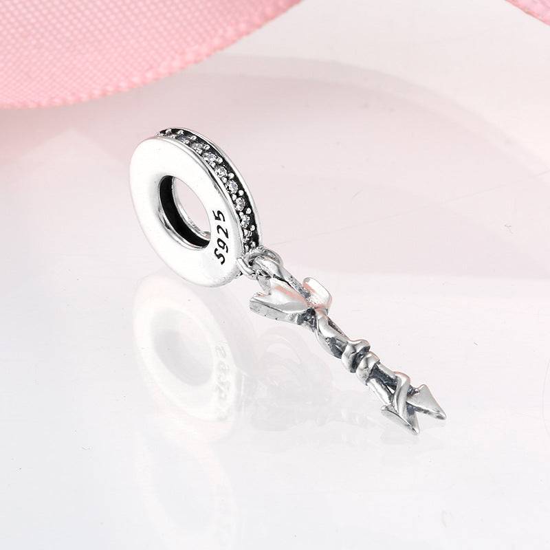 Silver arrow charm with sparkling accents