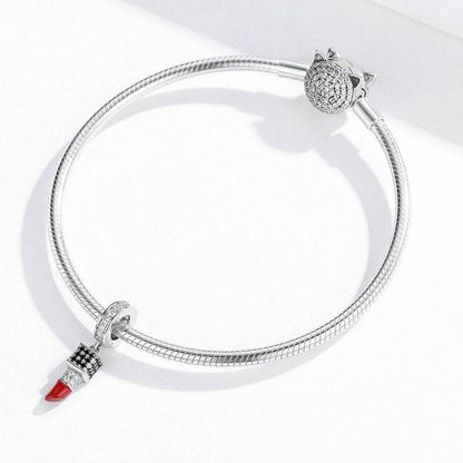 Silver bracelet featuring a lipstick charm