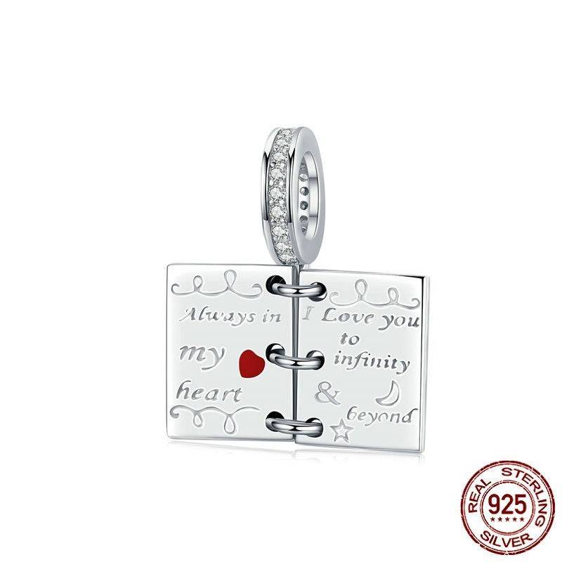 Romantic sterling silver charm with red heart and engraved messages.