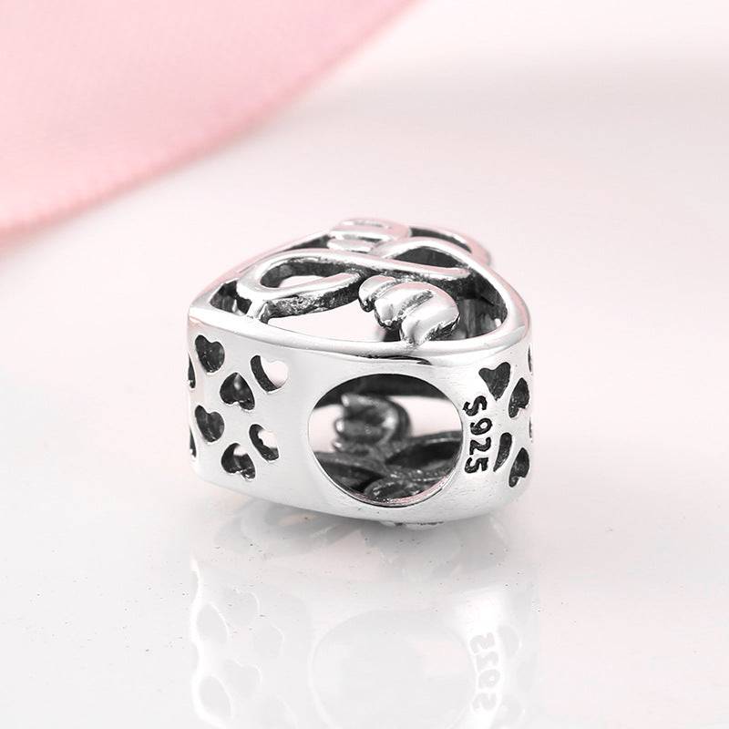 Heart-shaped charm with intricate heart designs