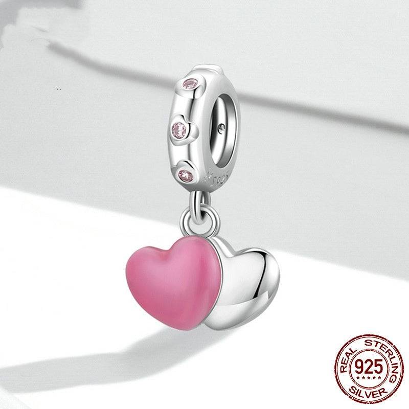 Close-up of Pink Heart Tag Charm in sterling silver with pink enamel heart and crystal-accented loop.