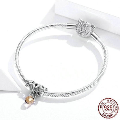 Sterling silver bracelet featuring an acorn charm with amber gemstone.