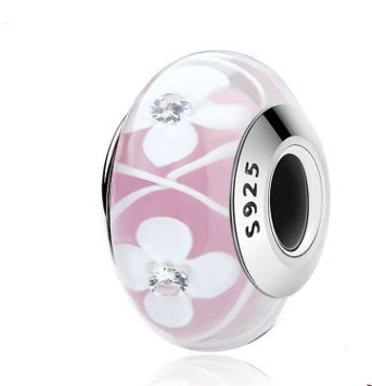 Pink glass bubble charm with floral design