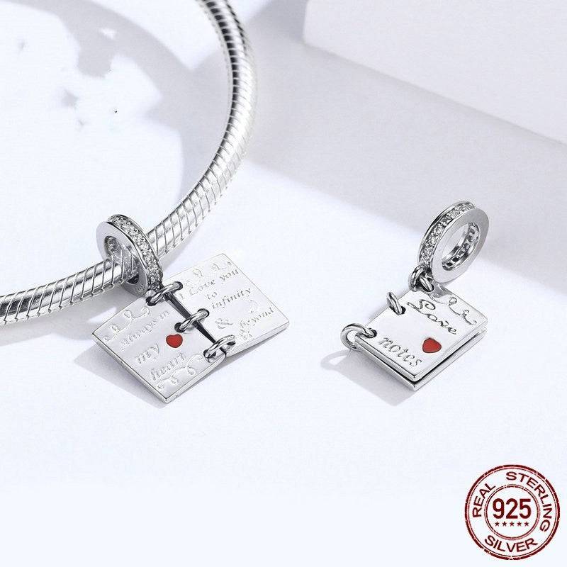 Love notes charm displayed with bracelet, featuring heartfelt engravings.