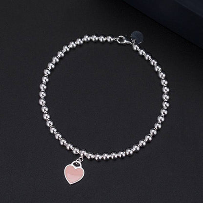 Silver bracelet with pink heart tag pendant