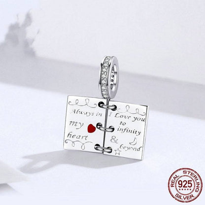 Close-up of love notes charm with 'Always in my heart' engraving.