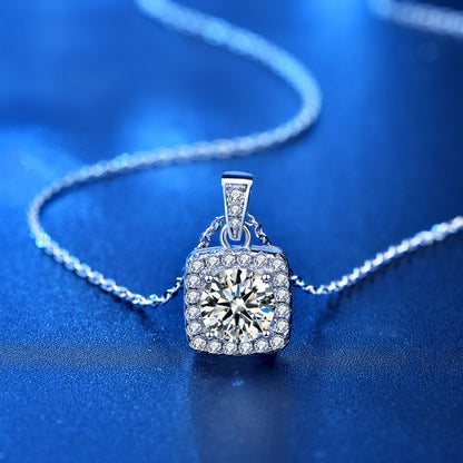 Square pendant moissanite necklace on a silver chain, elegantly arranged on a blue surface for a luxurious look.