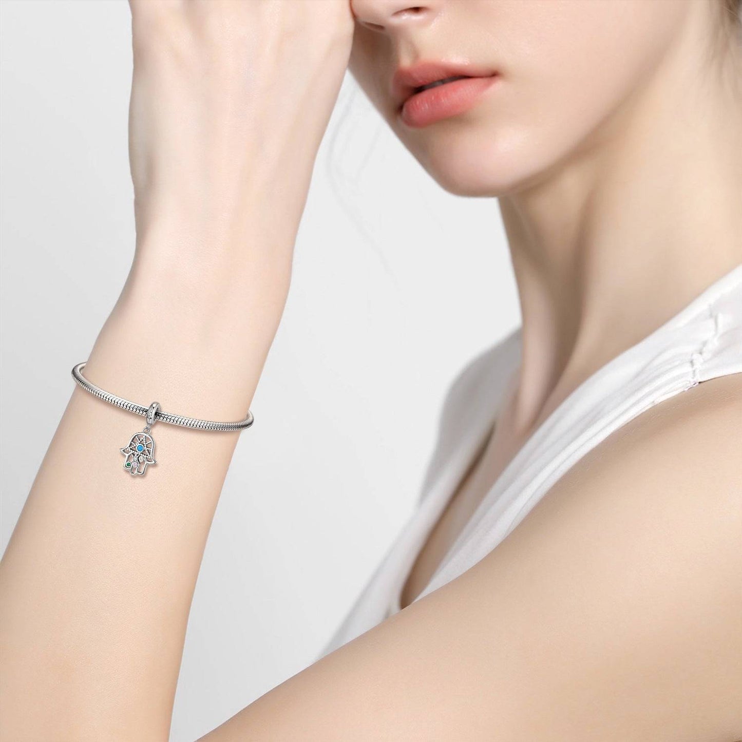 Woman wearing bracelet with Hamsa Hand charm