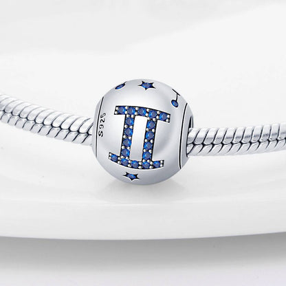 Gemini zodiac charm in sterling silver with blue crystal accents, a stylish addition to personalized jewelry collections.