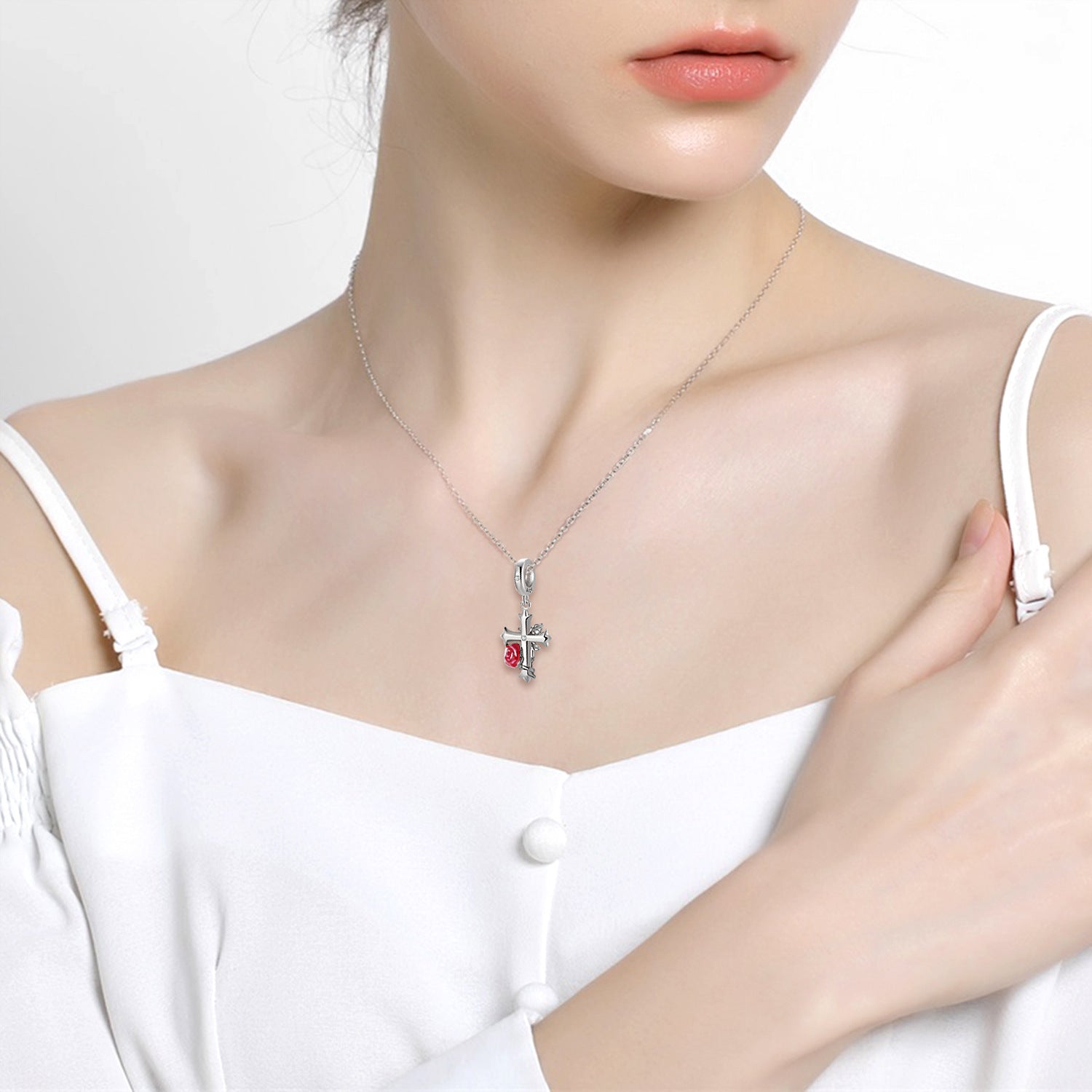 Rose Cross Charm worn as a necklace, showcasing its gothic-style silver cross and red rose. A meaningful jewelry piece symbolizing love and faith.