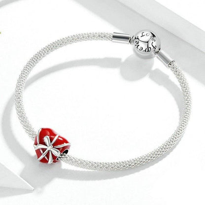 Silver bracelet with red heart charm and bow