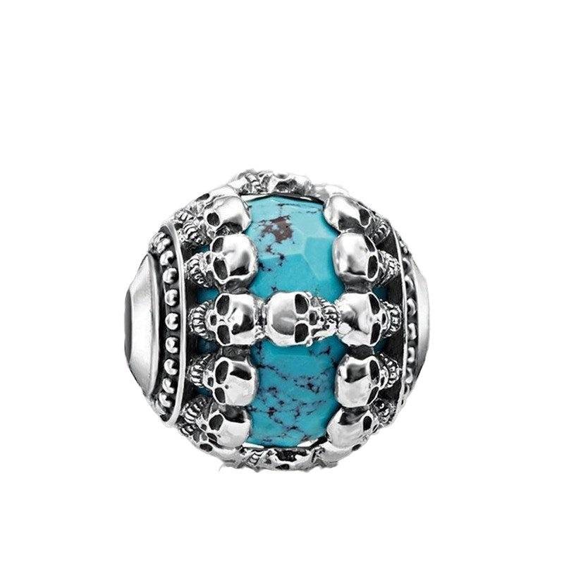 Turquoise skull charm with intricate silver details